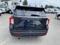 A black 2021 Ford Explorer viewed from the rear showing the tailgate lights and license plate area