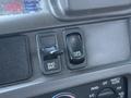 Close-up of control buttons in a 2004 Sterling LT9500 truck featuring an engine brake switch and a mirror heat switch