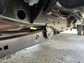 Undercarriage of a 2024 Ford F-550 showing the frame and mounting points with visible wiring and suspension components