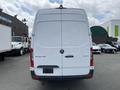 A 2025 Mercedes-Benz Sprinter van viewed from the rear with a white exterior and sleek design prominently displaying the model name on the back