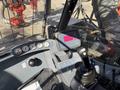 The interior control panel of a 2018 Sandvik Ranger DX800 featuring various gauges a joystick and a digital display for operating the machine
