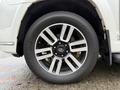 A close-up of a wheel from a 2018 Toyota 4Runner featuring a silver alloy rim and a Yokohama tire with visible tread patterns