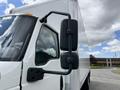 A 2022 International MV607 truck with a white body and large side mirrors reflecting the sky and surrounding area