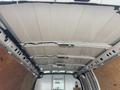 Interior view of a 2022 GMC Savana cargo van showing the roof and side panels with metal supports and wooden flooring
