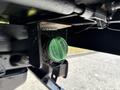 A green diesel fuel cap attached to a 2019 Ford F-550's fuel tank undercarriage