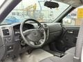 Interior view of a 2012 GMC Canyon showing the dashboard steering wheel and front seats
