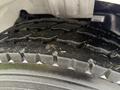 Close-up of a rugged tire from a 2005 Freightliner M2 106 showcasing its tread pattern and surface details