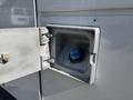 The image shows the fuel filler cap of a 2011 Ford F-550 with the cap opened revealing the fuel opening