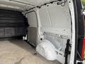 Interior of a 2019 Mercedes-Benz Metris cargo van showing an empty rear space with uninsulated walls and a wheel well on the left side