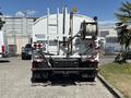 A 2008 International DuraStar truck with a white body featuring a hose reel and multiple taillights visible at the rear