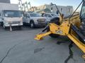 A 2013 JCB 510-56 Loadall positioned in the foreground featuring a yellow frame with large black tires and a telescopic arm for lifting and moving materials