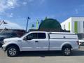 White 2019 Ford F-150 with a truck bed cap parked on a lot