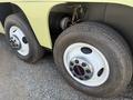 Close-up of the wheels and tires of a 1976 GMC Palm Beach showing chrome hubcaps with GMC logo and tread pattern on the tires