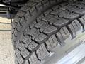 Close-up of a pair of rugged tires on a 2020 Ford F-550 showcasing deep treads designed for traction and stability