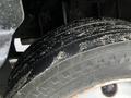 Close-up of a worn tire from a 2012 Mitsubishi Fuso FE displaying visible tread wear and dirt accumulation