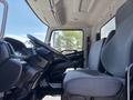 Interior view of a 2020 Hino 338 featuring a driver's seat and passenger seat with gray upholstery and a dashboard with steering wheel and controls visible