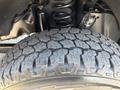 Close-up of a tire from a 2022 Ford F-350 SD with deep tread patterns designed for off-road traction and stability