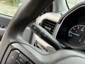 Close-up of the steering wheel and control stalk of a 2021 Ford F-150 highlighting the controls for wipers and headlights