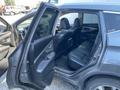 A 2017 Nissan Murano with its front and rear doors open showing the black leather interior and seating arrangement