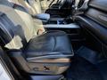 A black leather seat of a 2023 RAM 3500 pickup truck with adjustable controls visible on the side