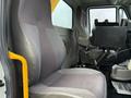 A driver's seat from a 2016 International 7400 truck with a gray and black fabric design featuring a high back and armrests