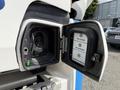 A close-up of the charging port on a 2022 Lion Lion6 electric truck showing a socket for connecting a charger and indicator lights for charging status