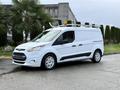A white 2017 Ford Transit Connect van with a ladder rack on the roof and distinctive alloy wheels positioned at an angle