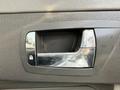 A chrome door handle on the interior of a 2008 Kenworth T370 truck with lock and unlock symbols displayed next to it
