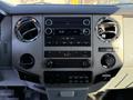 The dashboard of a 2010 Ford F-450 featuring radio controls air conditioning vents and various buttons and knobs