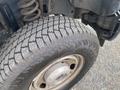 Close-up of a tire from a 2014 Ford F-350 SD showing deep treads and the wheel rim with visible bolts