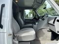 Interior view of a 1994 GMC Vandura 3500 showing driver and passenger seats with a simple dashboard and a cup holder