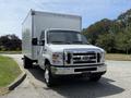 White 2018 Ford E-450 box truck with a flat front and chrome grille parked in a clear area