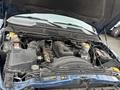 Engine compartment of a 2006 Dodge Ram 2500 with various components visible including the engine block battery and air intake system