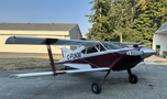A 1986 Sorrell Hiperbipe SNS-7 amateur-built aircraft with a maroon and white color scheme featuring a tailwheel design and two wings.