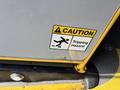 A caution sign with an illustration of a person slipping and the text "Caution Tripping Hazard"