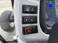 Control panel of a 2009 New Holland T4020 featuring buttons for lift, lowering, and hazard lights