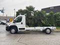 A 2023 RAM Promaster 3500 chassis cab with a bare cargo bed and no added bodywork is parked on a paved surface.