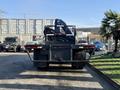 A 2015 Hino 358 truck viewed from the rear with a flatbed and a crane mounted on the back