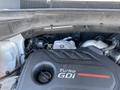 Engine compartment of a 2018 Hyundai Santa Fe featuring a Turbo GDi engine with various components and wiring visible