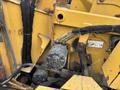 A close-up of a hydraulic component on a 2015 Vermeer Corporation BC1200XL with visible hydraulic lines and valves in yellow and gray color scheme