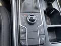 Close-up of a 2022 Kia Sorento center console featuring drive mode selector buttons for comfort eco sport and mud along with other control buttons