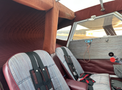 Interior of a 1986 Sorrell Hiperbipe SNS-7 with two seats featuring striped upholstery and harnesses in a compact cabin design