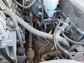 Close-up of the engine compartment of a 2013 Chevrolet Silverado 1500 showing various wires and components including hoses and metal parts