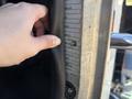 A person's hand is resting on the door of a 2020 Peterbilt 330 with a visible placard detailing vehicle specifications and tire sizes