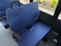 A blue fabric seat with seat belts designed for a 2020 Chevrolet Express van