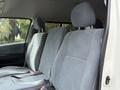 Interior view of a 2009 Toyota Hiace highlighting the front seats with textured gray upholstery