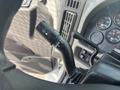 Close-up of a turn signal lever inside a 2012 International 7300 Workstar featuring various controls and indicators on the dashboard