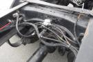 Close-up of the chassis of a 2015 Kenworth T660 showing hydraulic lines and mechanical components connected to the vehicle's frame