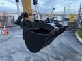 A close-up view of the bucket attachment of a 2023 Sany SY35U excavator with a black metallic finish and curved edges