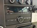 Dashboard of a 2020 Chevrolet Express featuring a digital display and various control buttons for audio and settings